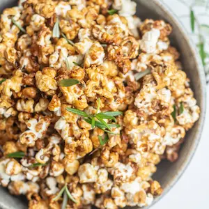 a close up of caramel popcorn in a bowl