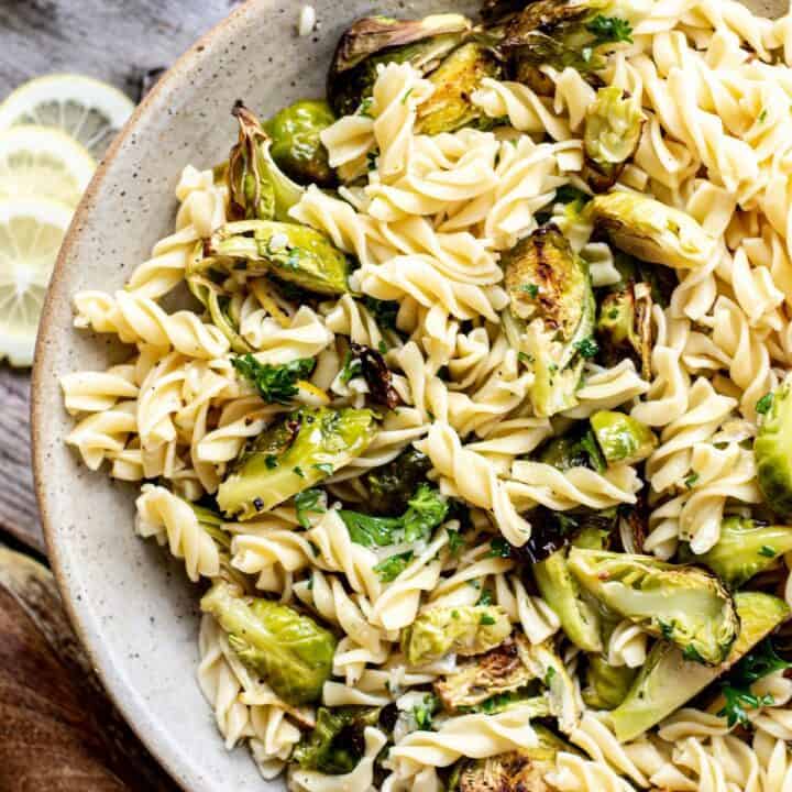 a bird' eye view of a bowl of fusilli pasta with roasted Brussels sprouts and lemon