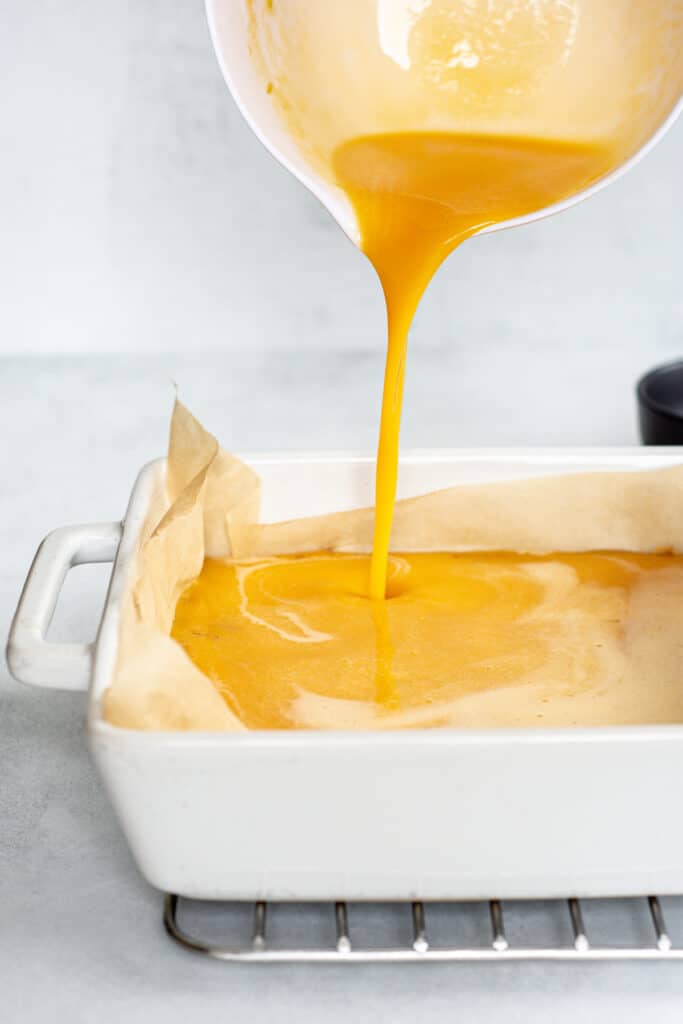 lemon curd being poured on pastry
