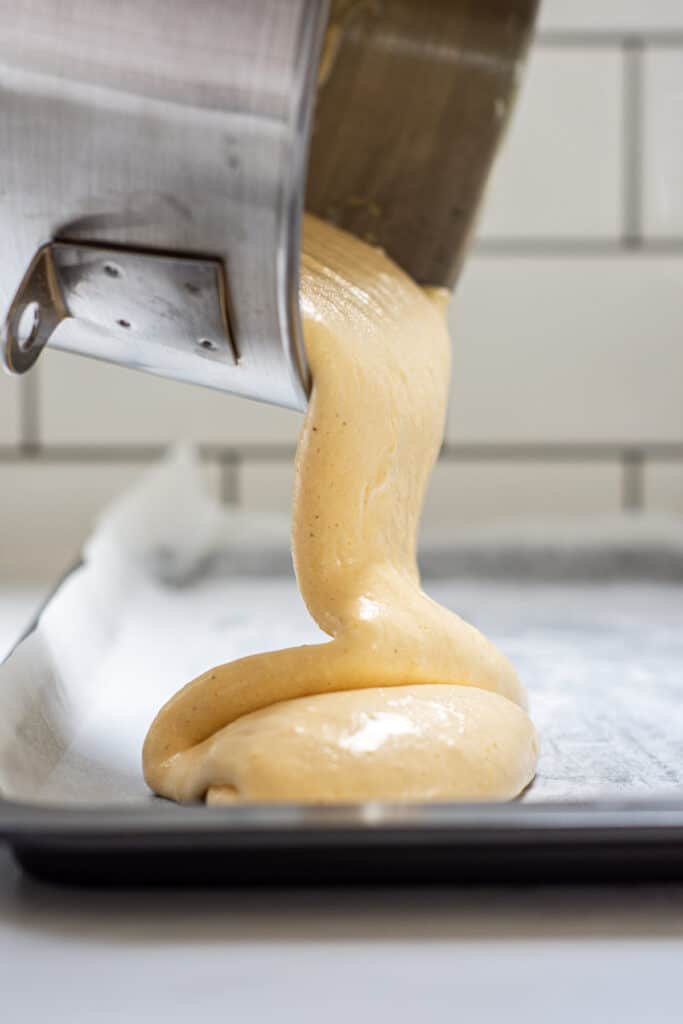 swiss roll batter being poured into flat tray
