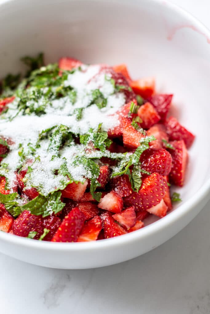 strawberries covered with mint and sugar