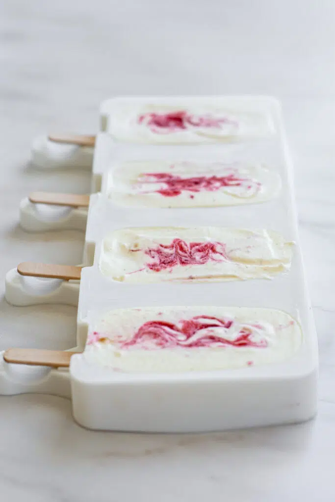 popsicle moulds with strawberry swirls